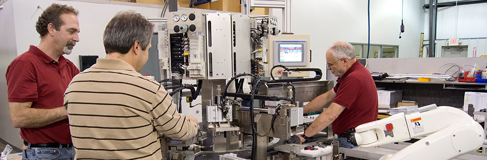 assembly techs testing a custom automated assembly machine